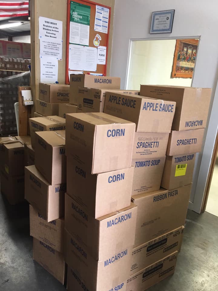 Organized food pantry with labeled boxes of groceries
